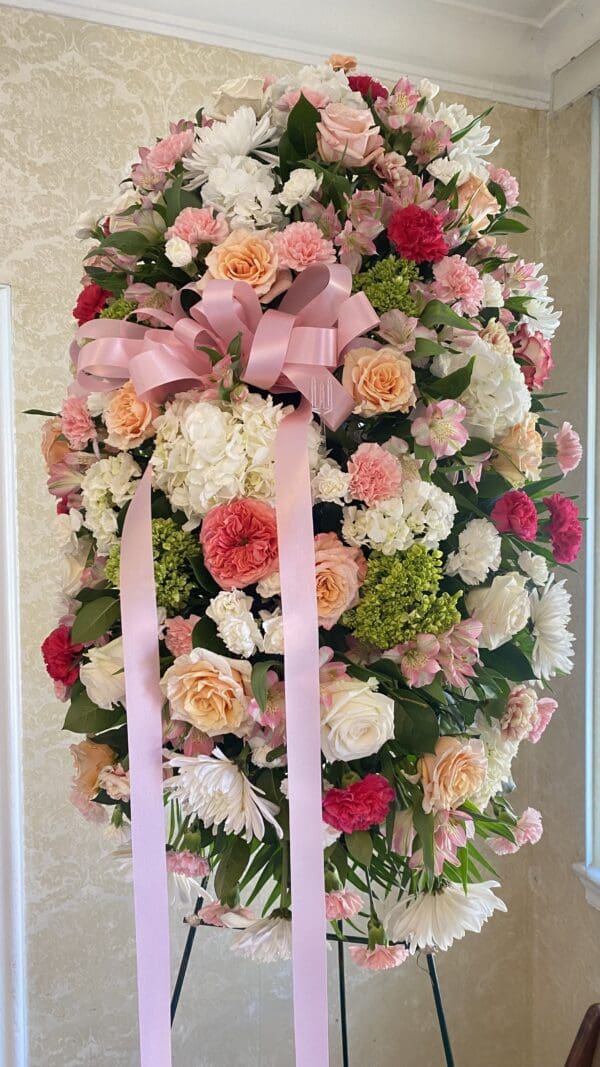 Pink and white funeral flower arrangement.